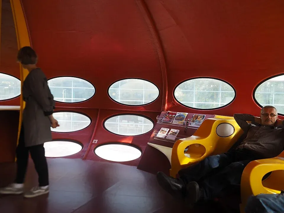 Red interior of a Futuro house with oval windows.